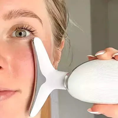 Woman achieving youthful glow with facial massager